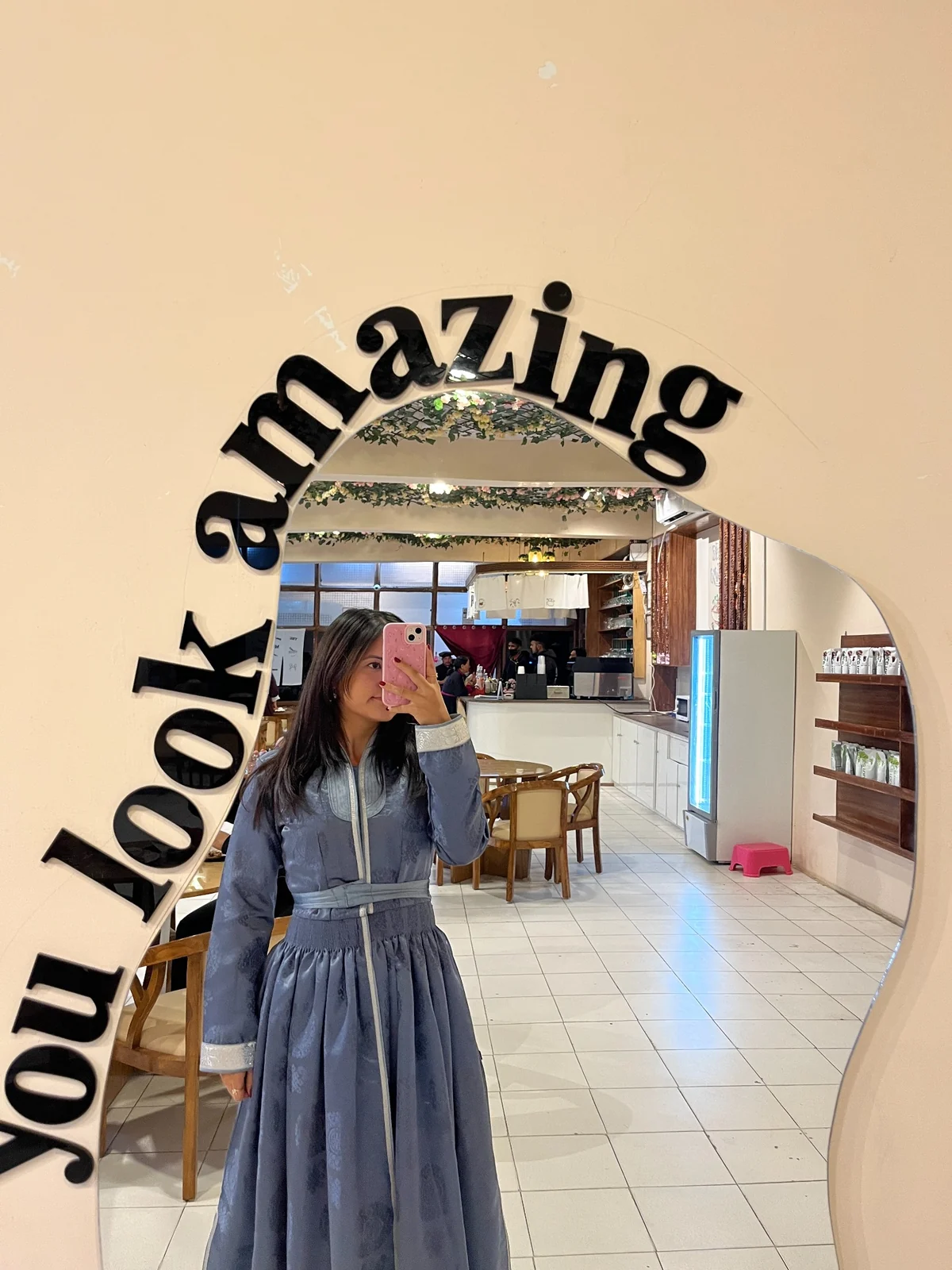 A guest taking a mirror selfie in K-Station café